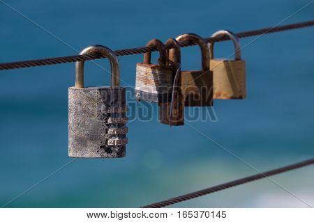 Closed padlocks on iron rope represent love and security