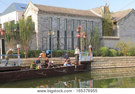 BEIJING CHINA - OCTOBER 29, 2016: Unidentified people fish at futong old street canal.