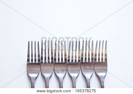 Silver fork neatly on a white table
