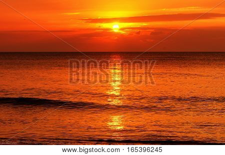 The water at Mai khao beach in Talang city on Phuket Island thailand overlooking the andaman sea at sunset.
