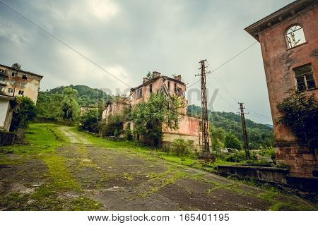 Abandoned mining ghost-town Jantuha, Abkhazia. Destroyed empty houses, the remains of the cars, remnant of The Georgian-Abkhazian war