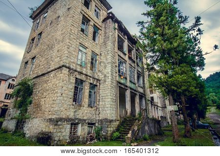 Abandoned mining ghost-town Jantuha, Abkhazia. Destroyed empty houses, the remains of the cars, remnant of The Georgian-Abkhazian war