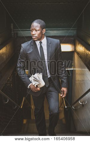 Businessman in full suit at Wall Street subway metro station