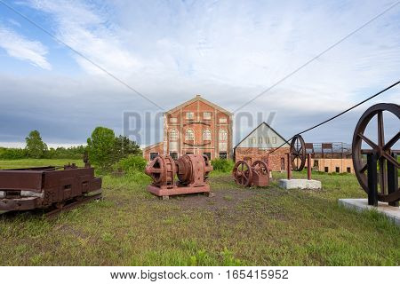 Old industrial equipment form leading lines to an abandoned factory. Building is from 1918 and part of an abandoned copper mine that is now a Historic National Park in Upper Michigan.