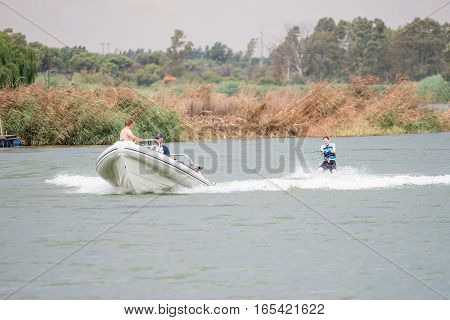RITCHIE SOUTH AFRICA - DECEMBER 30 2016: An unidentified skier being towed by a boat on the Riet River (reed river) at Ritchie a small town in the Northern Cape Province