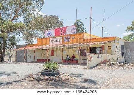 FAURESMITH SOUTH AFRICA - DECEMBER 31 2016: Unidentified people in front of a supermarket in Fauresmith a small town in the Free State Province