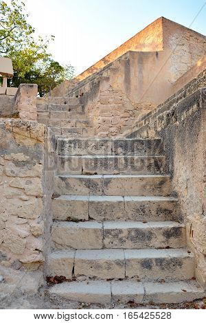 Old yellow stone staircase of limestone in the of Santa Barbara castle