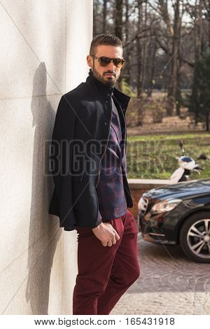 MILAN ITALY - JANUARY 14: Fashionable man poses outside Antonio Marras fashion show building during Milan Men's Fashion Week on JANUARY 14 2017 in Milan.