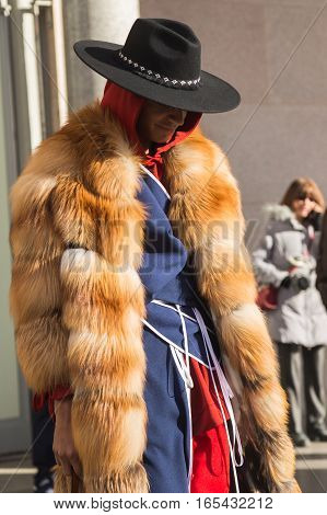 MILAN ITALY - JANUARY 14: Fashionable man poses outside Antonio Marras fashion show building during Milan Men's Fashion Week on JANUARY 14 2017 in Milan.