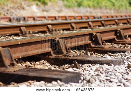 Close Up of Loose Bolt and Rotten Sleeper on Ageing Railway Line Showing Signs of Disrepair