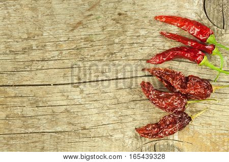 Dried Chili Peppers On Old Wooden Background. Sale Of Spices. Preparing Spicy Food. Place For Your T