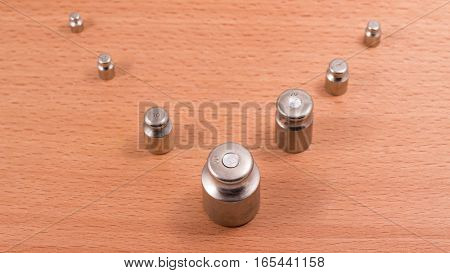 these metal weights are put on manual scales to counterbalance a subject on the other hand