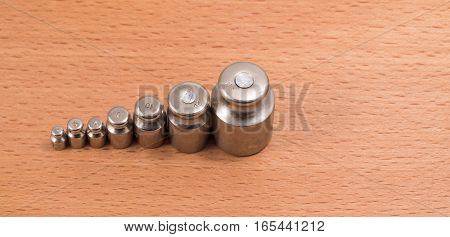 these metal weights are put on manual scales to counterbalance a subject on the other hand