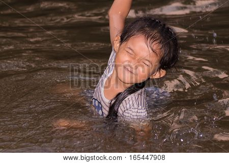 asian children girl in river , enjoy
