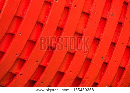 Red rows of painted wooden side of a fishermen boat