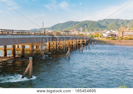 View of Uji city with the Uji Bridge Uji River houses mountain and blue sky Japan. beautiful landscape of wooden bridge in uji city.