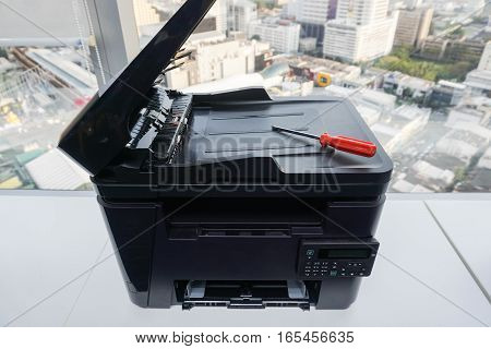 red screwdriver on printer for repair assistance