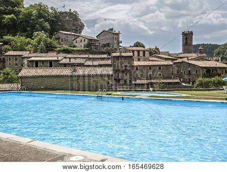 Spain Catalonia. Rupit - a small ancient town of stone in the territory of the Natural Park of the volcanic Garrotxa. Public pool.