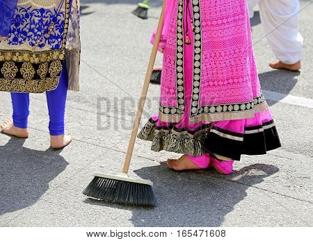 Barefoot Women Of Sikh Religion With Colorful Clothes Sweep The