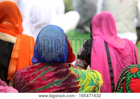 Woman With A Headscarf To Cover Her Head During A Gathering Of P