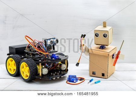 two robots are on the table robots screwdrivers wires servo