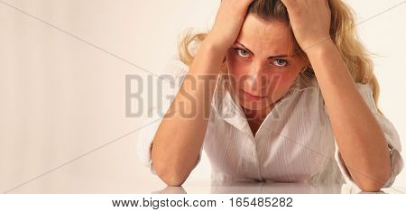 Troubled woman biting her fistas as symbol of failure in business. Close up portrait.