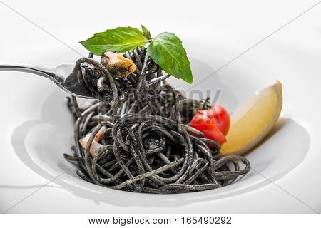Dish painted black cuttlefish ink spaghetti with seafood