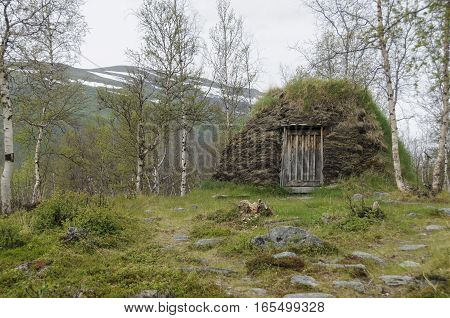 Sami culture: a a turf hut (darfegoahti) in a Sami Camp in Abisko National Park