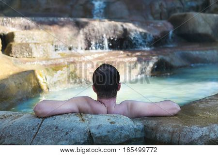Men relaxing in a swimming pool at termal resort