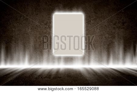 Backlit poster hanging on the concrete wall in mysterious glowing interior. Background, template, mock up