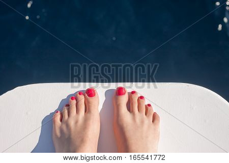 vacation holiday wooman feet on white yacht bow above sea