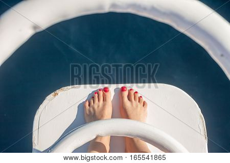 vacation holiday wooman feet on white yacht bow above sea