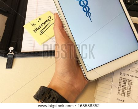 Healthcare technology access shopping online on mobile device Confused person holding tablet over health insurance policy bill doing research of medical costs and finding affordable health insurance by looking into options with question 