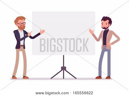 Young handsome successfull businessmen near the standing presentation display board, pointing with hands, talking about startup, demonstration of managment ideas, full length, copy space