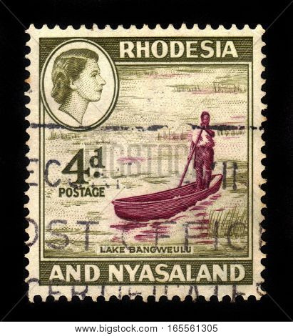 Rhodesia and Nyasaland- CIRCA 1959: A stamp printed in United Kingdom shows Queen Elizabeth II and Lake Bangweulu, circa 1959