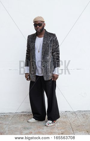 MILAN ITALY - JANUARY 15: Fashionable man poses outside Damir Doma fashion show building during Milan Men's Fashion Week on JANUARY 15 2017 in Milan.