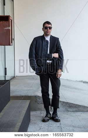 MILAN ITALY - JANUARY 15: Fashionable man poses outside Damir Doma fashion show building during Milan Men's Fashion Week on JANUARY 15 2017 in Milan.