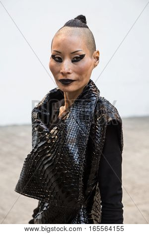 MILAN ITALY - JANUARY 15: Fashionable woman poses outside Damir Doma fashion show building during Milan Men's Fashion Week on JANUARY 15 2017 in Milan.