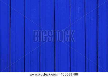 Texture of old wooden planks with peeling color paint