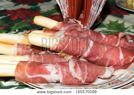 Breadsticks wrapped with thin slices of ham