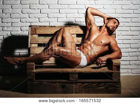 Handsome Muscular Man On Wooden Bench