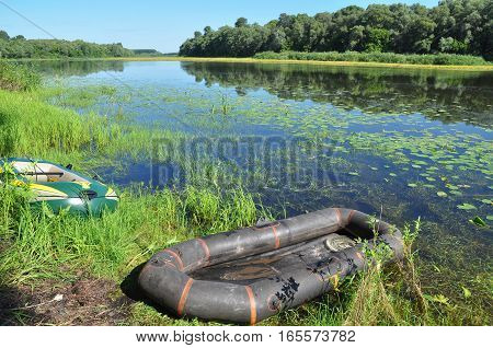 Fishing boats on the riverbank. Summer Fishing with boats.