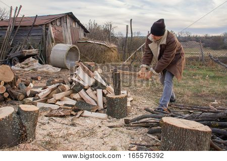 a man chopping wood in the village.