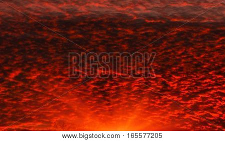 Fiery orange sunset colorful and speckled clouds.