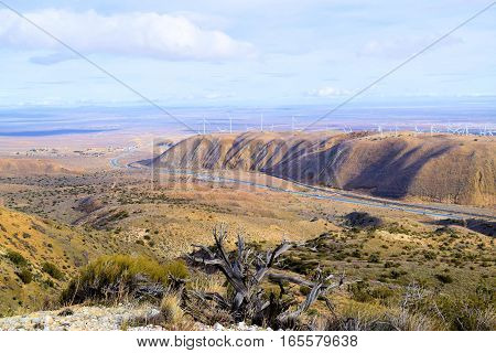 Barren and desolate landscape with sagebrush and chaparral plants overlooking the Mojave Desert taken in Tehachapi Pass, CA