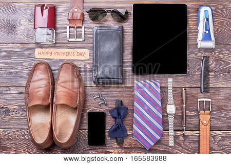 Accessories and Father's Day card. Gadgets, wallet and shoes. Complete dad's look by accessories.