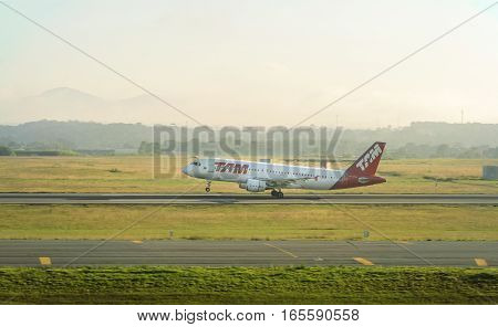 Curitiba, PR, Brazil - December 26, 2016: TAM Airlines plane taking flight at Internacional Afonso Pena airport in Curitiba.