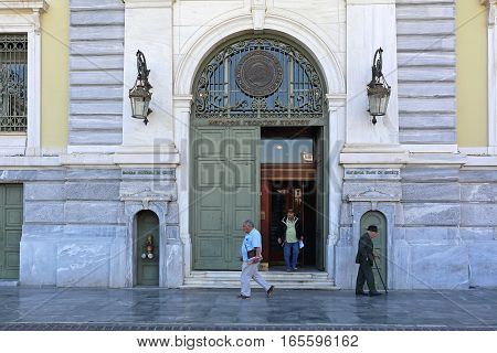 ATHENS GREECE - MAY 04: National Bank of Greece in Athens on MAY 04 2015. People in Front of National Bank of Greece Headquaters Building in Athens Greece.