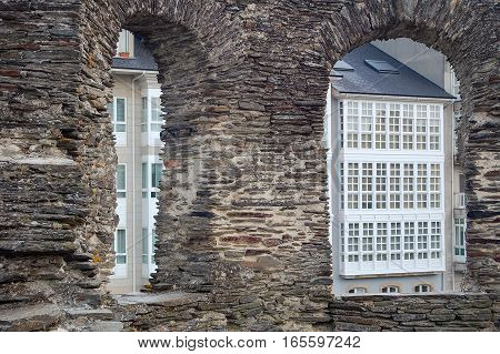 Windows through windows of the ancient Roman wall of Lugo in Galicia, Spain