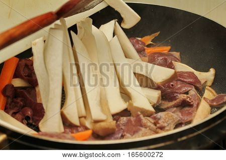 Cooking ,fried Eryngii Mushroom With Pork Liver And Carrot.